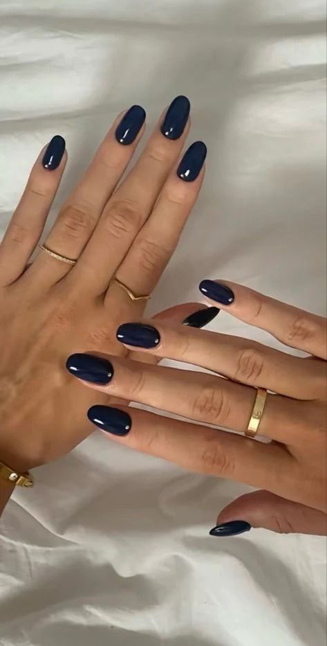 Elegant Navy Blue Nail Polish with Chic Oval Design and Gold Accents.