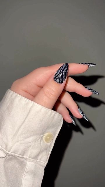 Chic Black and Silver Swirling Nail Design: Elegant and Sophisticated Aesthetic.