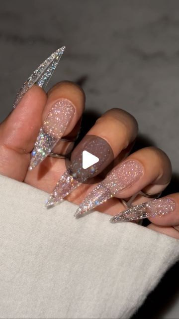 Glamorous Sparkling Stiletto Nails: A Stunning Blend of Nude and Glitter Finishes.