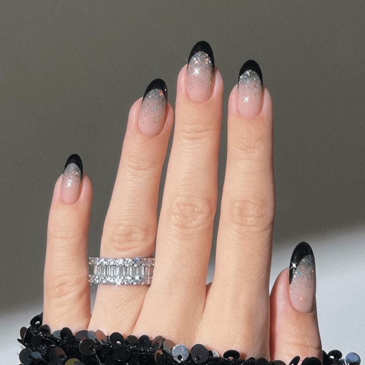 Sophisticated Ombre Nail Design: Soft Pink to Black with Sparkling Silver Glitter