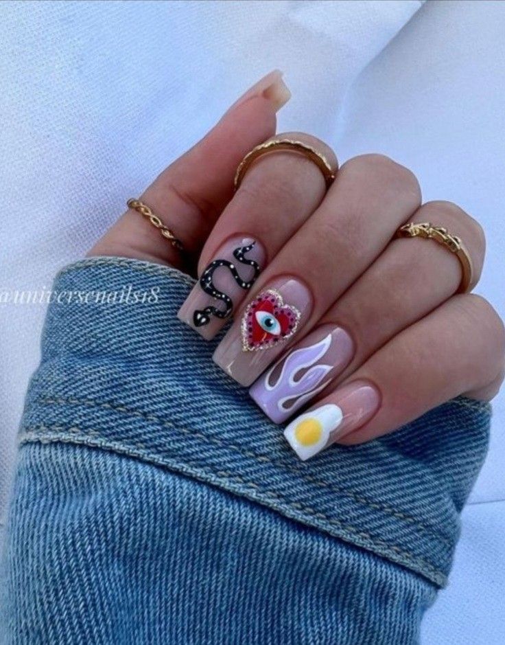 Eclectic Nail Design with Snake Motif, Heart Eye, Flames, and Sunny-Side-Up Egg on a Bold Nude Base.