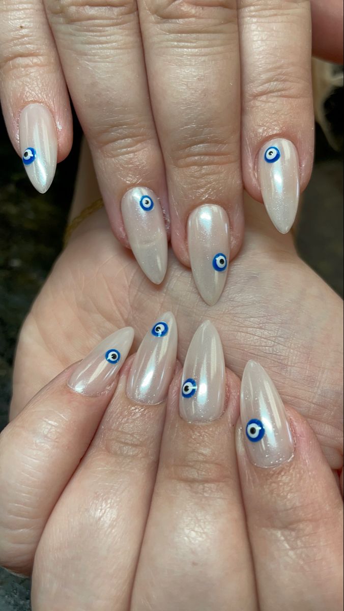 Chic Almond-Shaped Nails with Glossy Finish and Whimsical Blue Evil Eye Accents