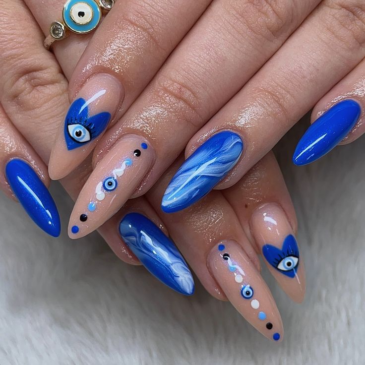 Striking Blue Nail Design with Intricate Patterns and Glossy Finish.