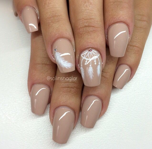 Sophisticated Nude Nail Design with Intricate Feather and Dreamcatcher Accents