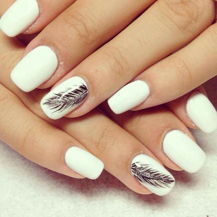 Elegant White Nails with Black Leaf Designs: A Modern Floral Chic Statement.