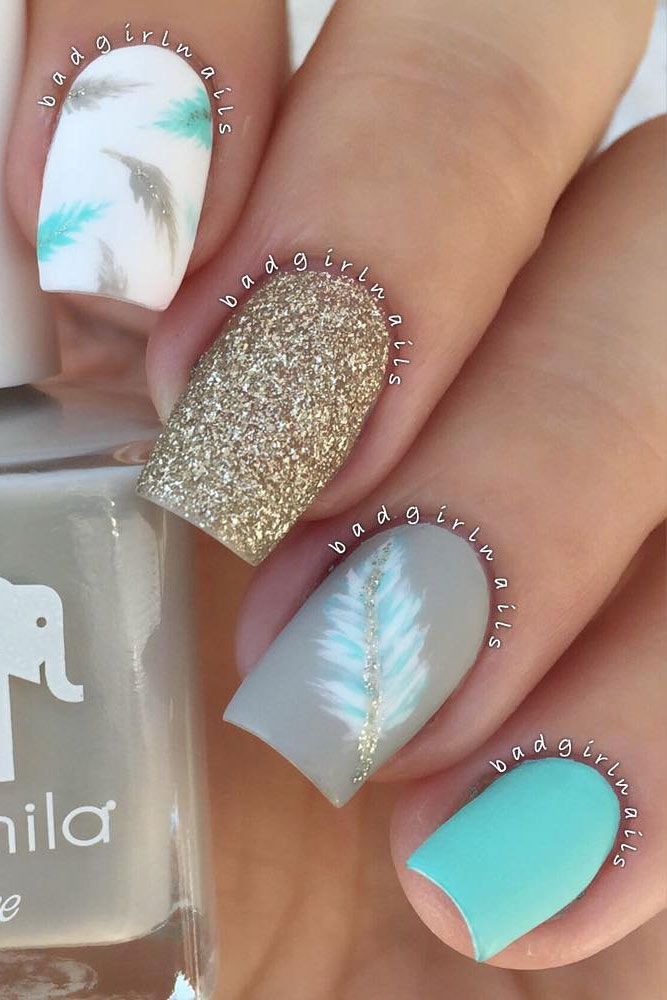 Chic Nail Design: Textured Feathers on White Base with Glitter and Aqua Gray Accent.