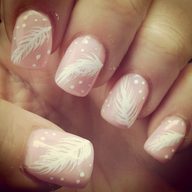 Charming Soft Pink and White Feather Nail Design with Whimsical Polka Dots