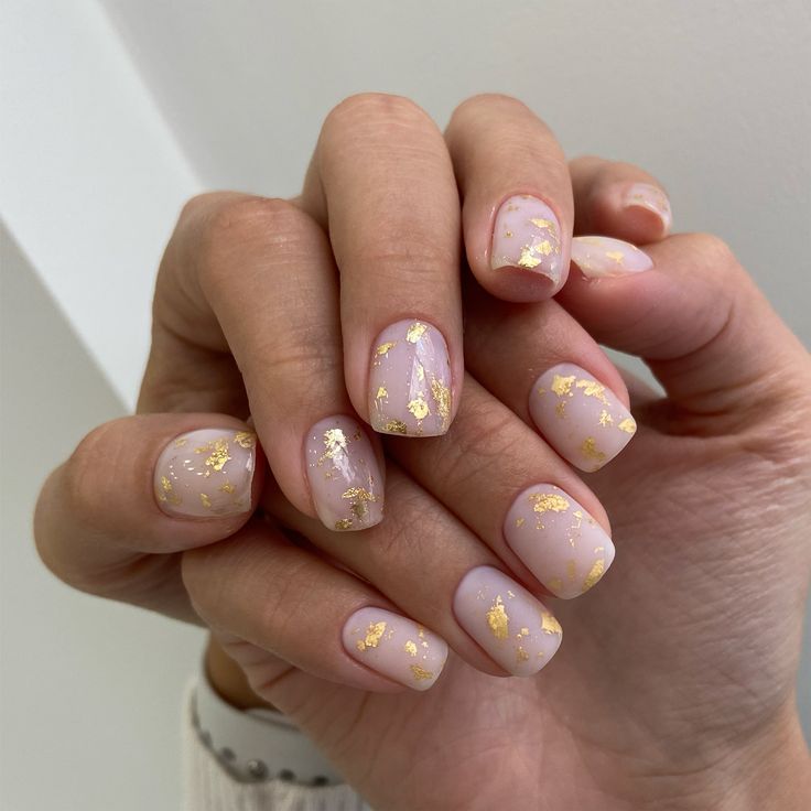 Sophisticated Nude Nail Design with Delicate Gold Flakes for Any Occasion