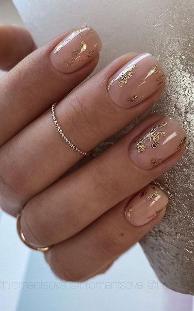 Chic Nude Nail Design with Delicate Gold Accents for Versatile Elegance.