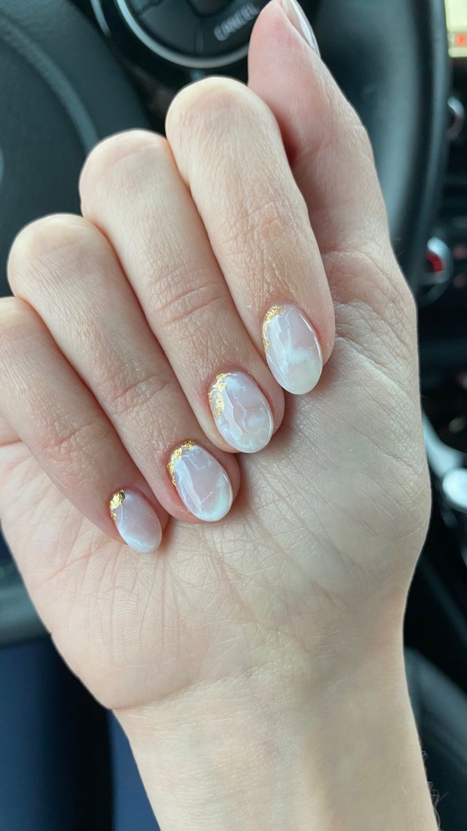 Chic Marble Nail Design with Glossy Finish and Delicate Gold Accents.