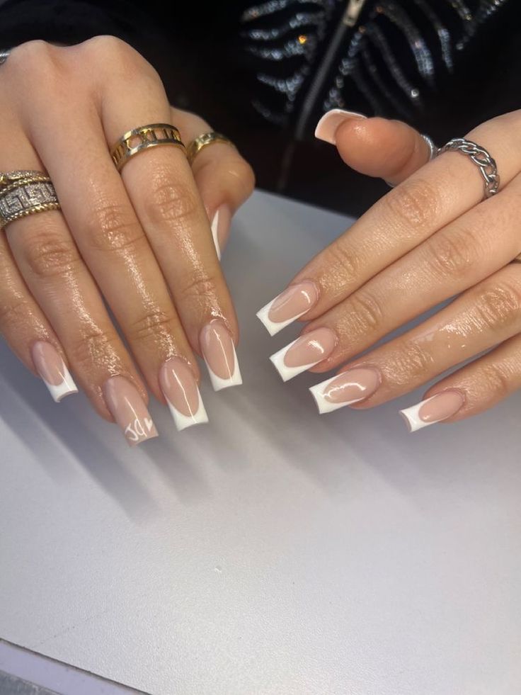 Modern Elegant French Tip Nail Design with Nude and White Colors.