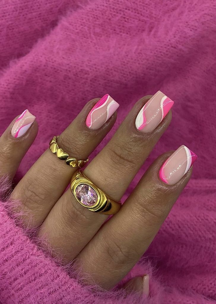 Chic Nail Design: Soft and Neon Pink with Wavy White Accents and Statement Rings.