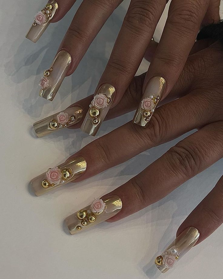 Sophisticated Nude Nail Design with Intricate Floral Accents and Golden Beads.