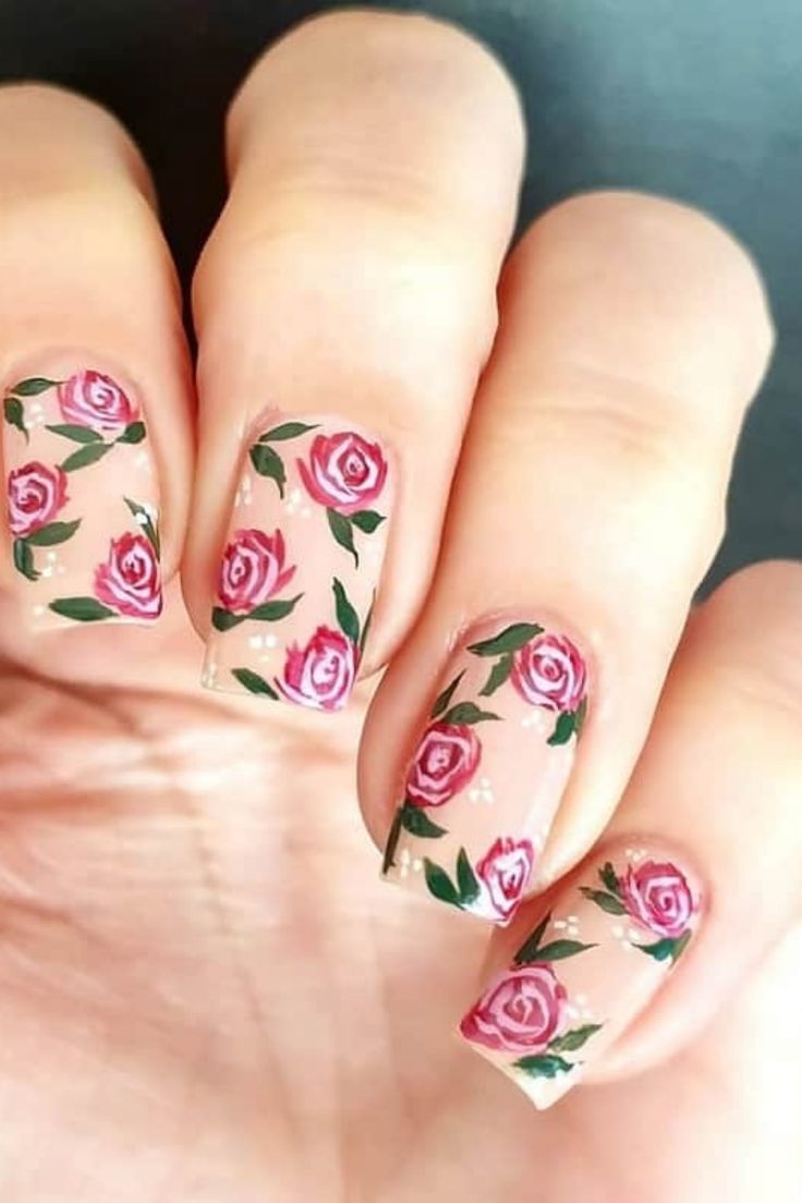 Delicate Floral Nail Design: Blush Pink Base with Roses and Green Leaves for a Charming Spring Vibe.