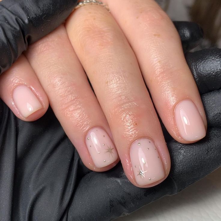 Elegant Nude Nails with Shimmer and Whimsical Star Accents