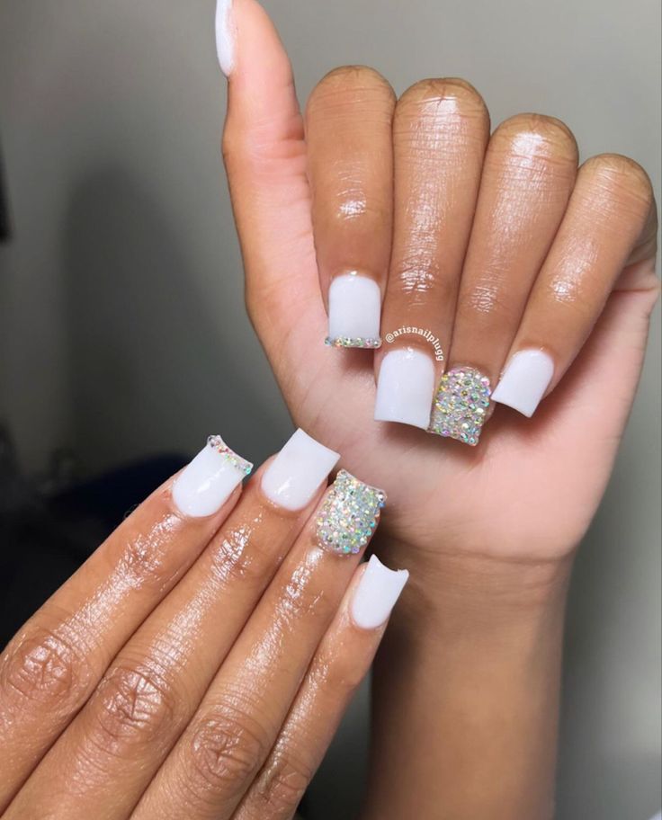 Sophisticated Chic: Elegant Soft White Nail Design with Glitter and Rhinestone Accents