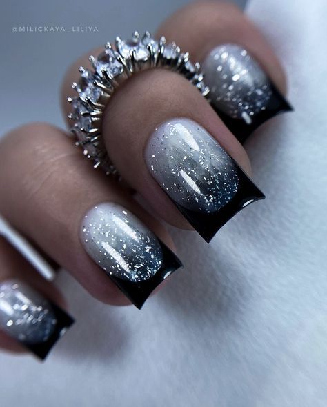 Elegant Ombre Nail Design: Shimmering Silver with Bold Black Tips and Glitter Accents