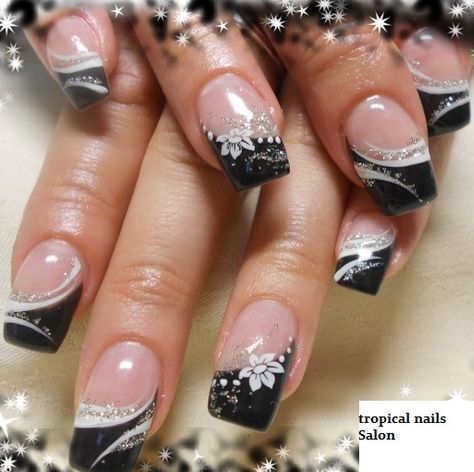 Sophisticated Black and White Nail Design with Glossy, Matte Finishes and Floral Accents.