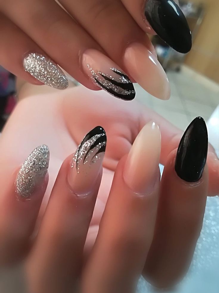 Chic Nail Design: Elegant Blend of Glossy and Textured Finishes in Black, Nude, and Glittering Silver.