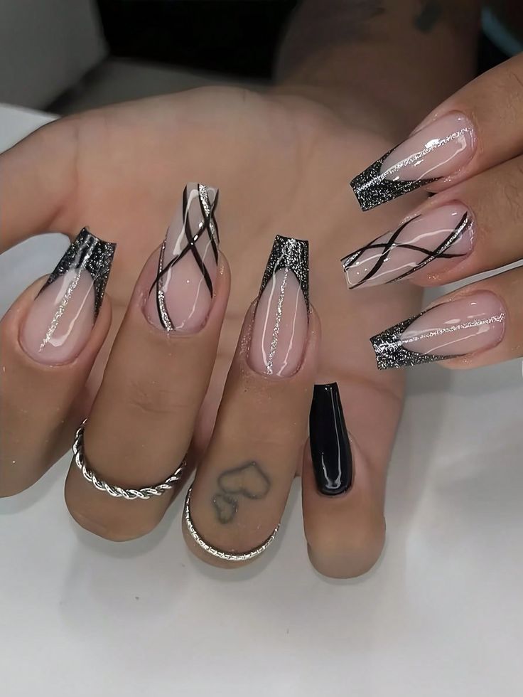 Sophisticated Nail Art: Sheer Pink and Black with Glittery Tips and Silver Accents