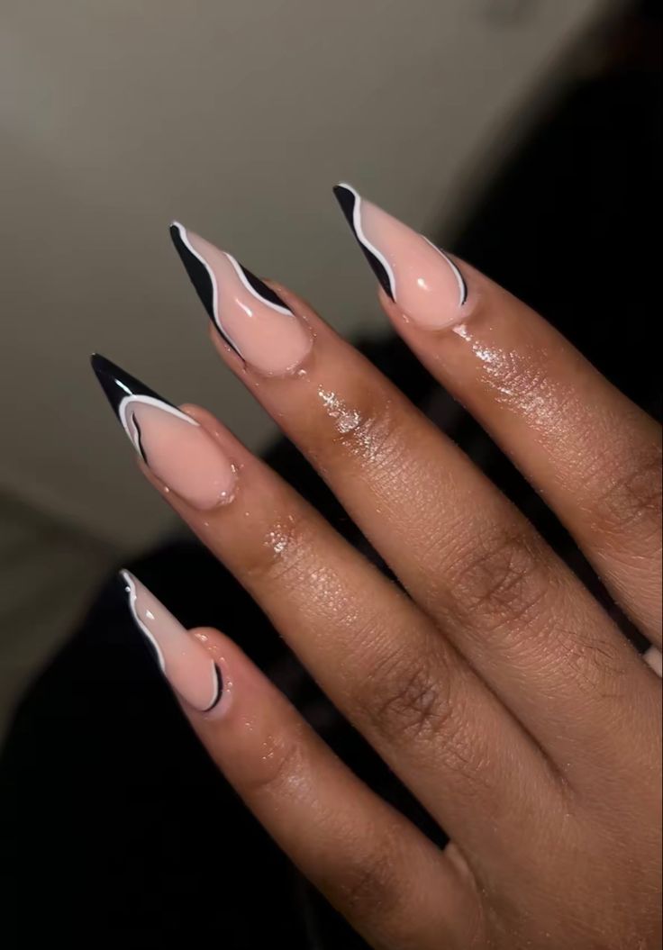 Elegant Almond-Shaped Nails: A Chic Fusion of Soft Nude and Bold Black Accents.