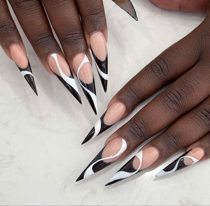 Captivating Black and White Stiletto Nails: A Bold Fusion of Elegance and Style.