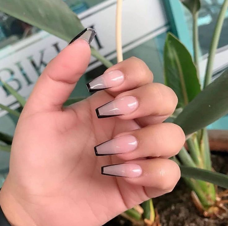 Elegant Ombre Nail Design with Sharp Black Tips: A Chic Blend of Classic and Contemporary Aesthetics.