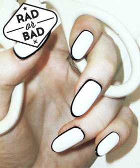 Chic Minimalist Nail Design: Sleek White Base with Striking Black Tips and Elegant Oval Shape.