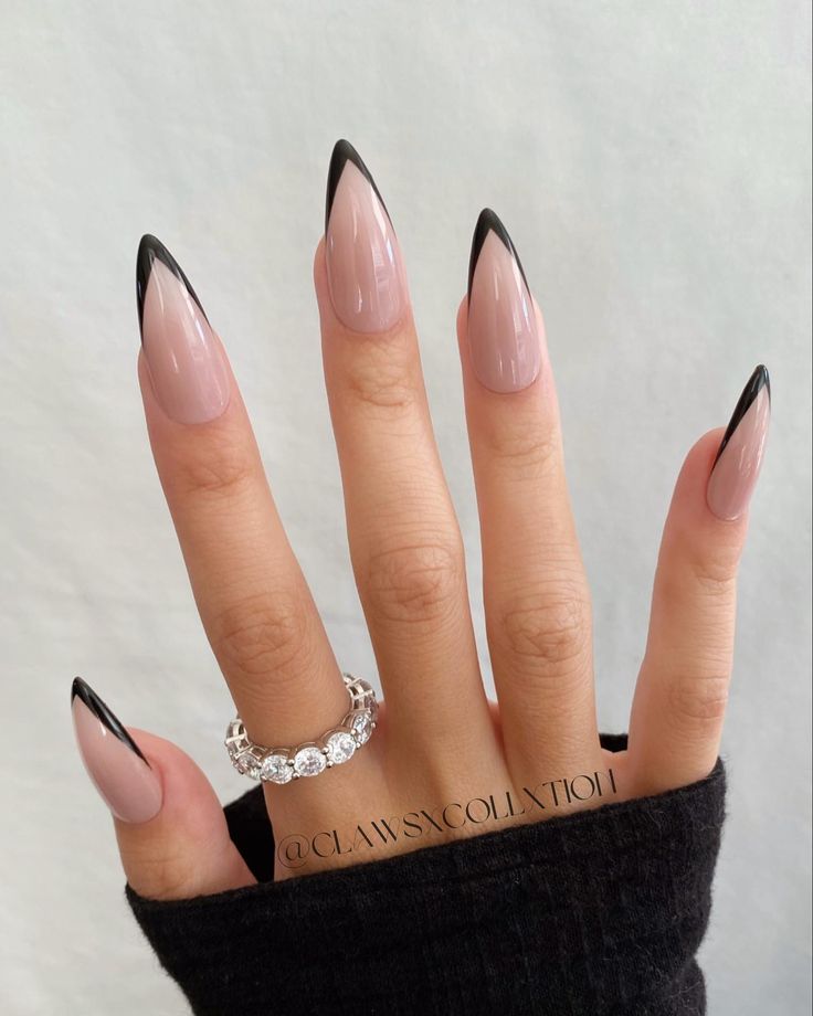 Chic Stiletto Nails: Sophisticated Nude Base with Bold Black Tips