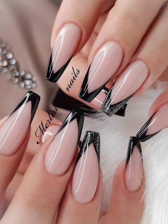 Elegant Nude and Black Nail Design with Sparkling Glitter Accents.