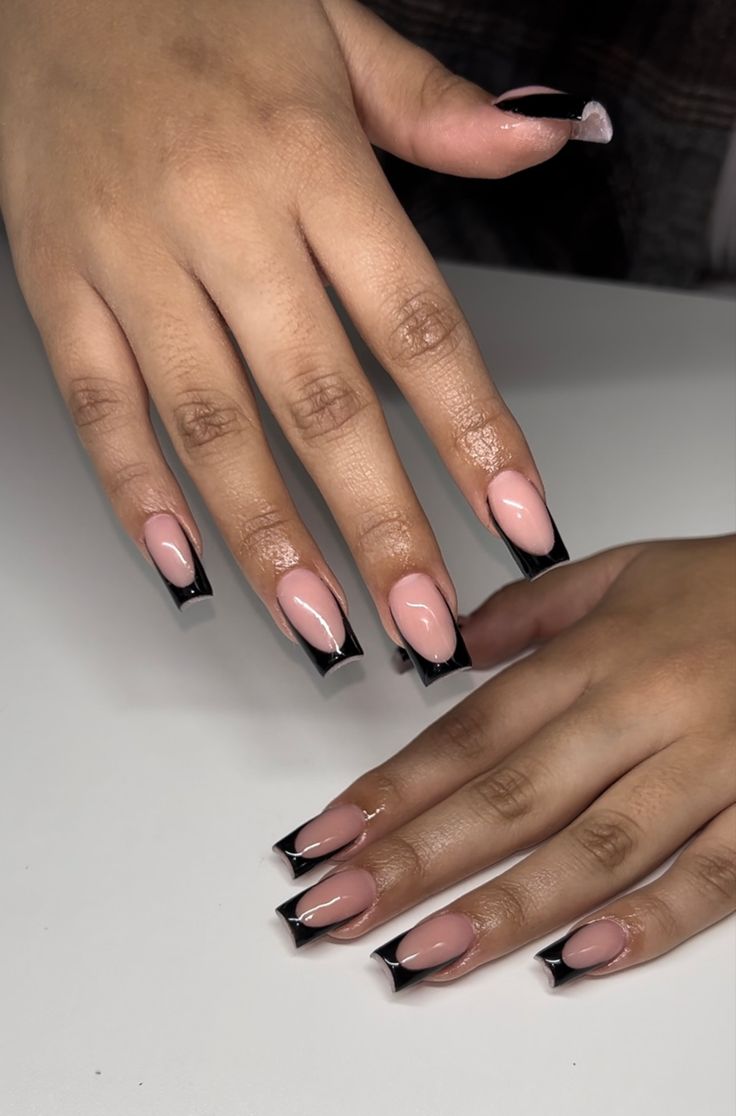 Sophisticated Nude and Black Nail Design: Chic Contrast with Glossy Finish.