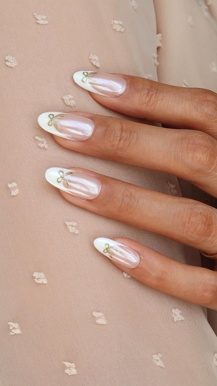 Elegant Sheer Nail Design with White Tips and Intricate Green Bow Accents.