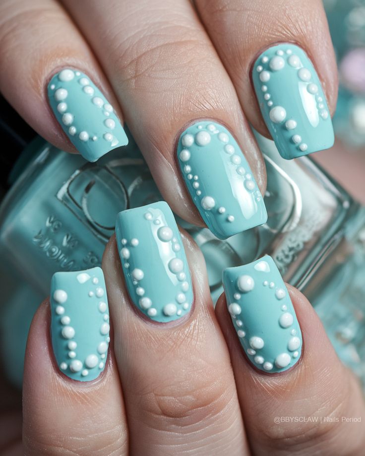 Whimsical Textured Turquoise Nail Art with Playful White Embellishments