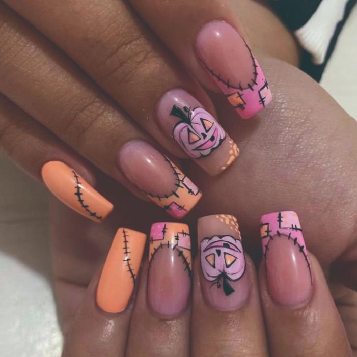 Whimsical Halloween Nail Art with Playful Pumpkin Motifs and Festive Patterns in Vibrant Colors.