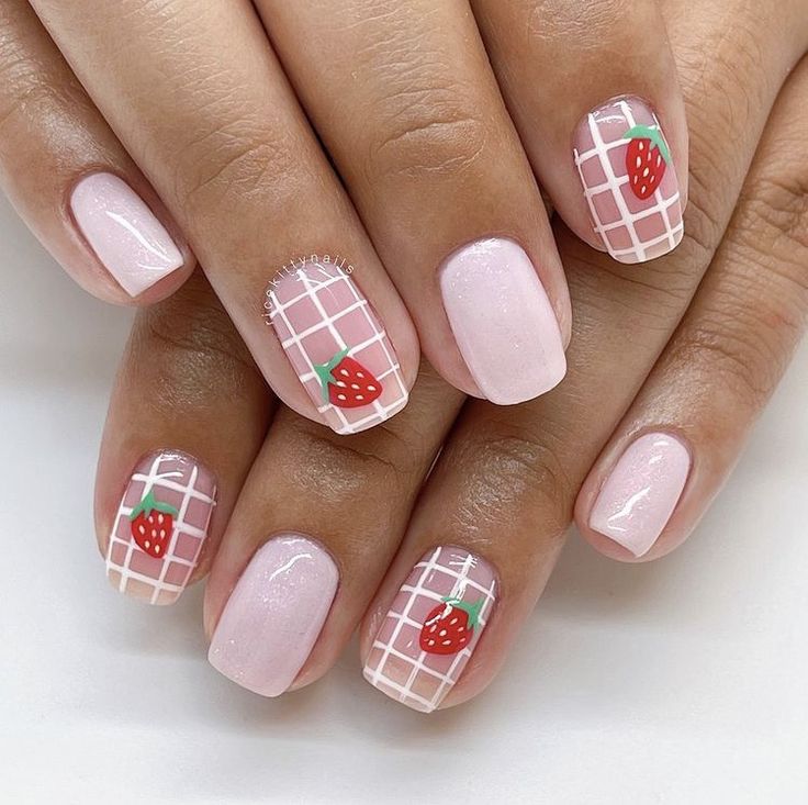 Charming Strawberry Nail Design: Soft Pink Base with Glossy Finish and Playful Red Accents.