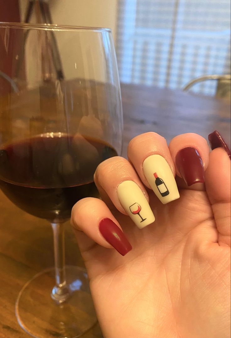 Chic Burgundy and Cream Nail Design with Intricate Wine Artistry for Any Occasion.