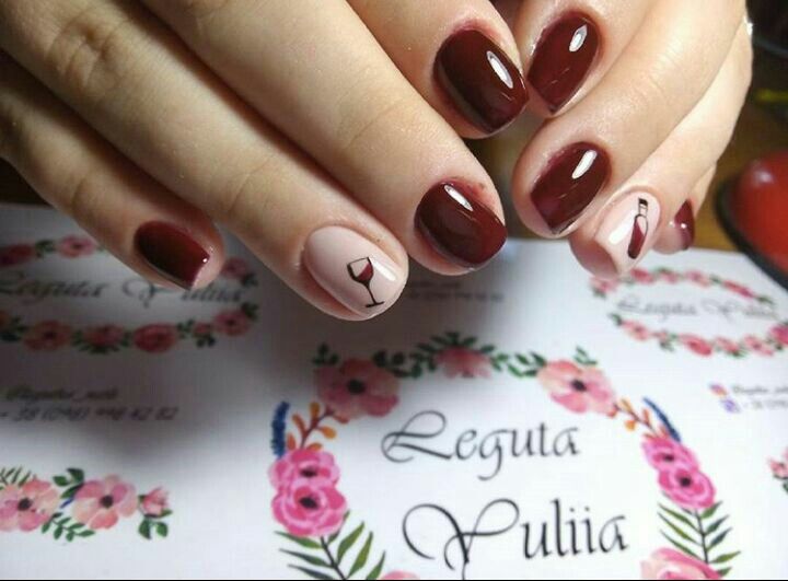 Sophisticated Burgundy Nail Design with Playful Wine Glass Accent.