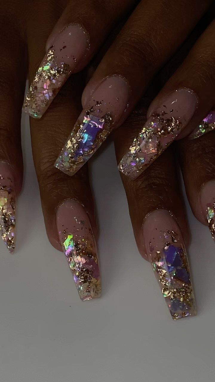 Glamorous Nude Nail Design with Iridescent Shattered Glass and Gold Glitter Accents.