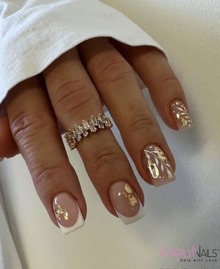 Sophisticated Elegant Nail Design with Nude and White Tips Accented by Gold Foil.