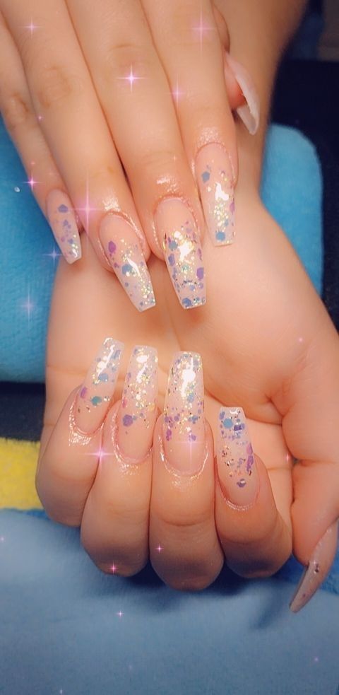 Whimsical Elegance: Clear Base Nail Design with Blue and Purple Glitter Accents