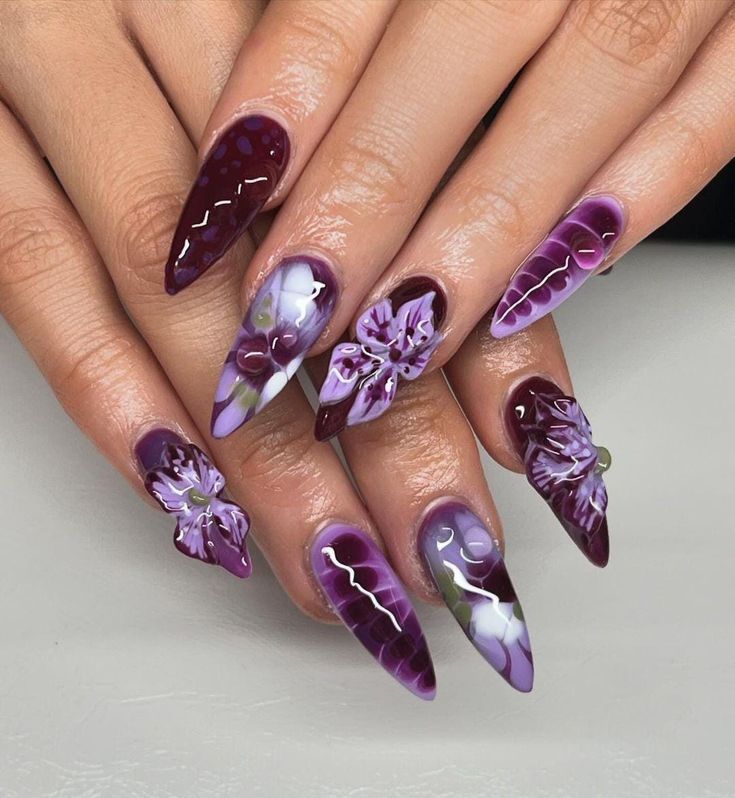 Elegant Floral-Inspired Nail Design in Rich Purple with 3D Accents and Glossy Finishes.