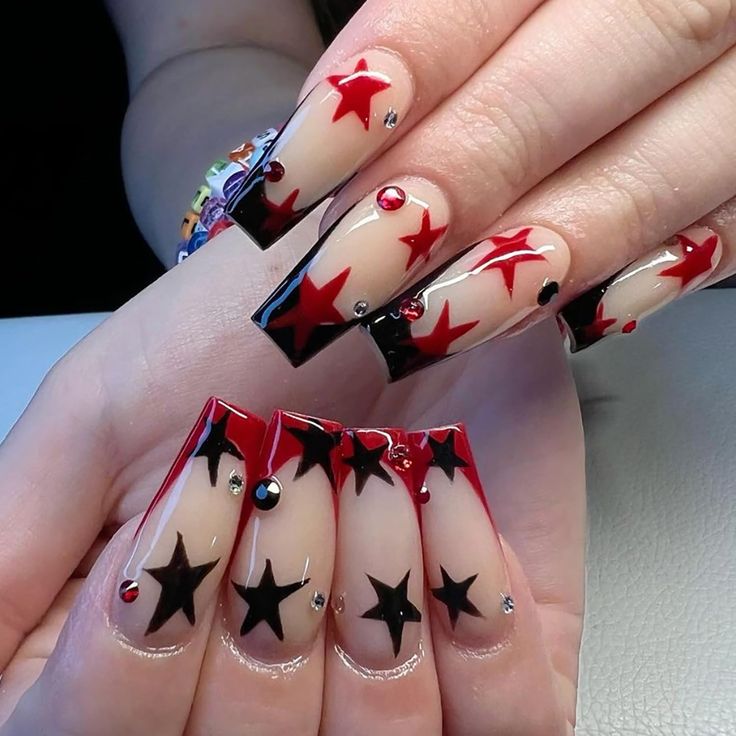 Elegant Star-Themed Nail Design with Striking Colors and Sparkling Accents.