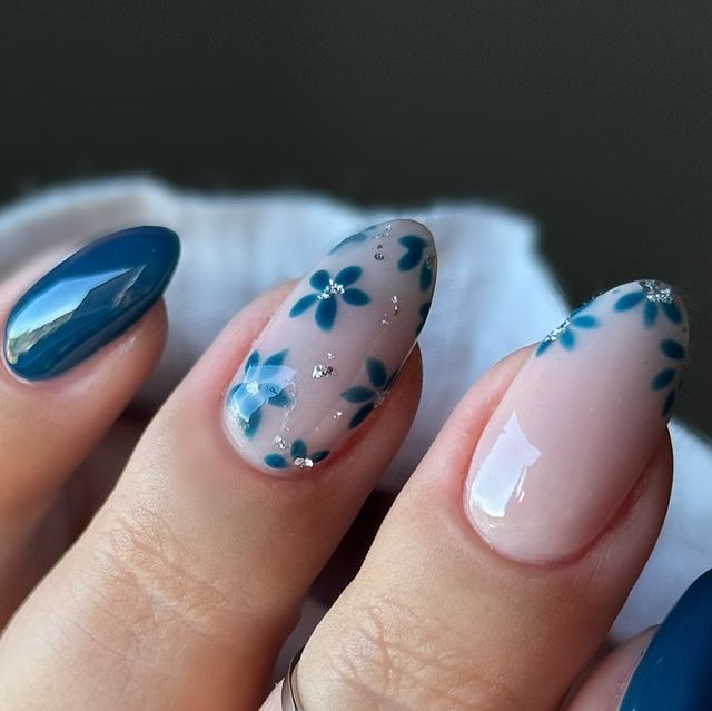 Elegant Floral Nail Design with Blue Flowers and Glossy Teal Accents.