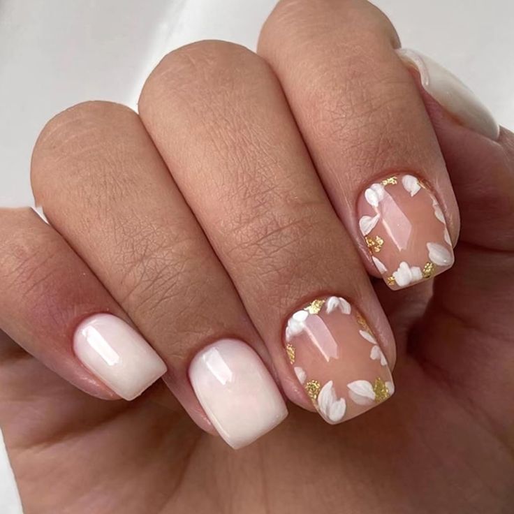 Elegant Floral Nail Design with Neutral Shades and Gold Accents.