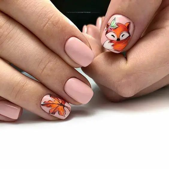 Charming Fall Nail Design: Soft Nude Base with Playful Fox and Autumn Leaves.