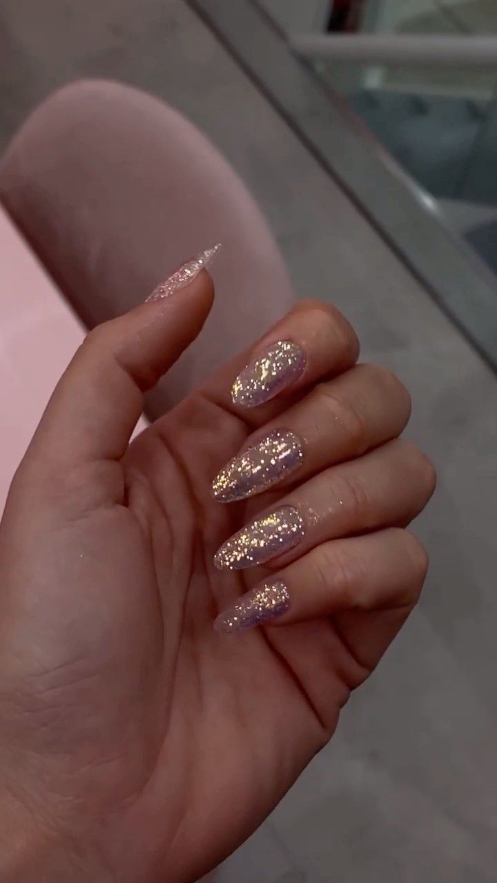 Chic Almond-Shaped Nails: Soft Pink with Sparkling Glitter for Everyday Glamour.