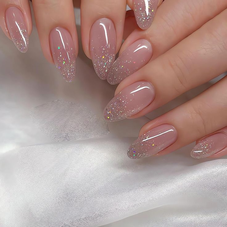 Elegant Almond-Shaped Nails with Soft Nude Base and Sparkling Glitter Gradient