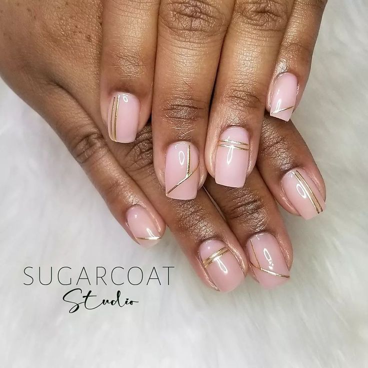 Sophisticated Nude Nails with Gold Geometric Accents for Elegant Style.