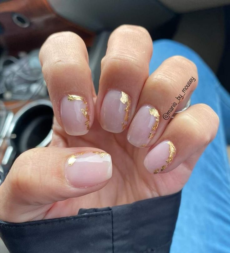 Chic Nude Nail Design with Glamorous Gold Foil Accents.