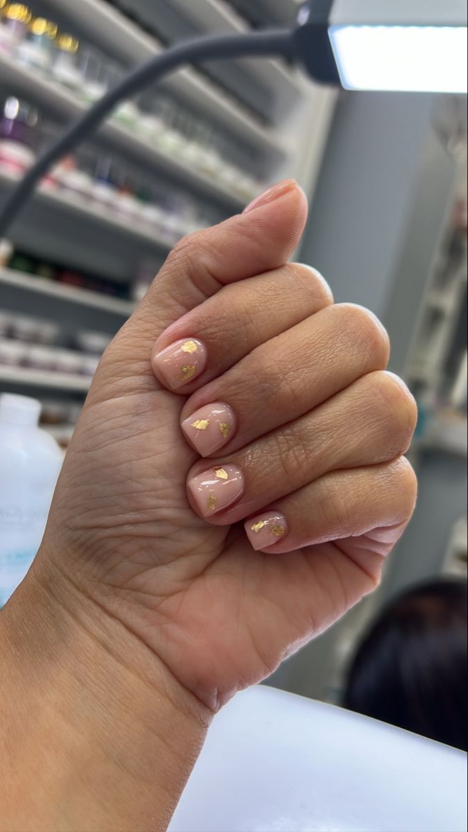 Sophisticated Nude Nail Design with Delicate Gold Foil Accents